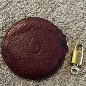 Super cute maroon Cartier coin purse. Used condition. Includes LV Lock & Key